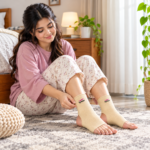 Woman wearing beige Tynor Anklet D03 supports on both ankles